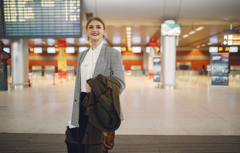Traveller checking the flight schedule in an airport departure hall