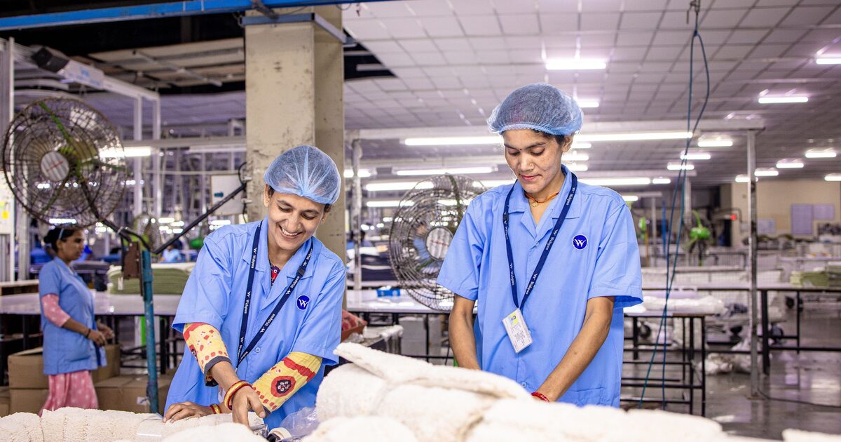 Factory workers assembling products on a textile production floor